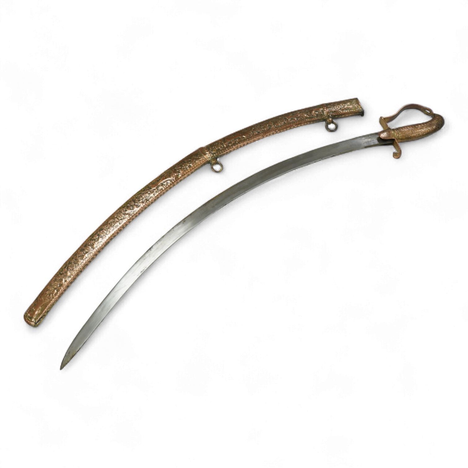 An early 19th century Indian sabre with curved single edge blade, copper grip and stirrup hilt, in its copper scabbard embossed with lions, scrolling foliage and flowers